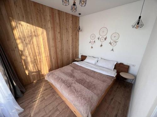 阿拉木图Alma house - White的一间卧室设有一张大床,铺有木地板