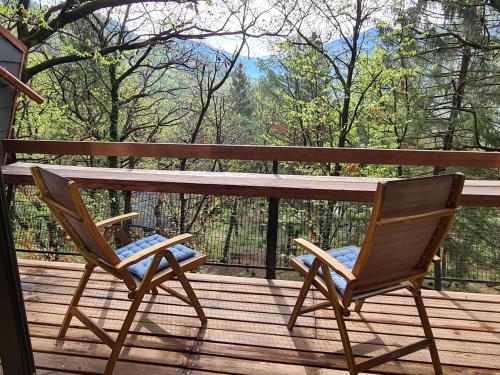 TermineChalet Bosco della Bella - Casa 6 - ZUG by Interhome的木头景甲板上的两把椅子