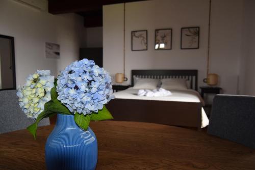 穆希亚Monasterio y Pensión de Moraime的卧室里一张桌子上蓝色花瓶