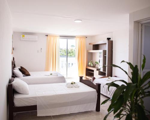 哥伦比亚港La Niña Mire的酒店客房设有两张床和窗户。