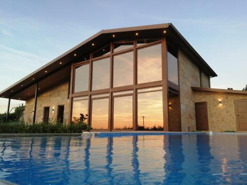 桑亨霍Casa Albarari Boutique Double Rooms with access to shared Infinity Pool的一座房子前面设有游泳池