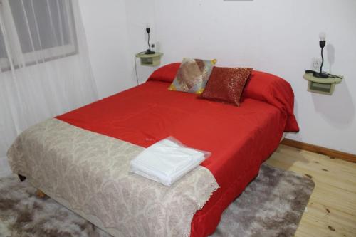 圣佩德罗Cabañas Santa Rita的一间卧室配有一张带红色毯子的床