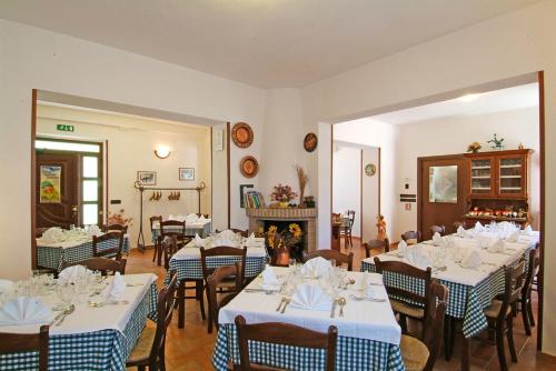 佩斯卡拉Agriturismo Il Tratturo的餐厅配有桌椅和白色及蓝色的桌布