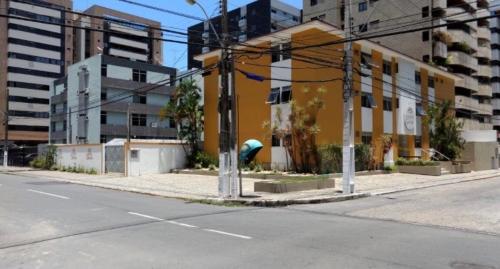 马塞约Hotel Porto Grande的一条空的街道,路边有一座黄色的建筑
