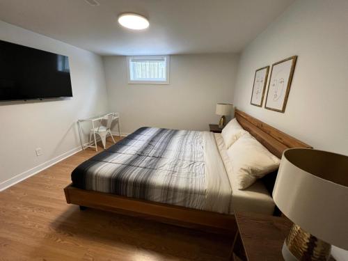 巴里Letitia Heights !B Spacious and Quiet Private Bedroom with Shared Bathroom的一间卧室配有一张床和一台平面电视