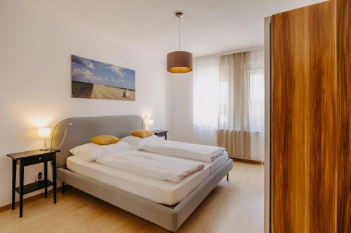 伊尔米茨Ferienwohnung Illy的一间卧室配有带白色床单和黄色枕头的床。