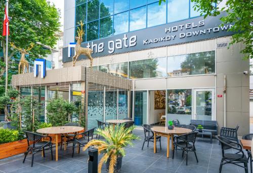 伊斯坦布尔The Gate Kadıköy Downtown的大楼前设有桌椅的餐厅