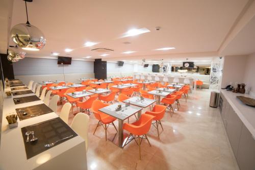 大坎皮纳Intercity Campina Grande Citymix的用餐室配有桌子和橙色椅子