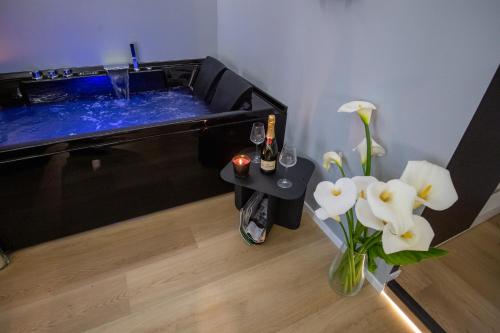 巴里Contemporaneamente 147 - Modern & Comfort Rooms的热水浴池,配有花瓶和饮料桌