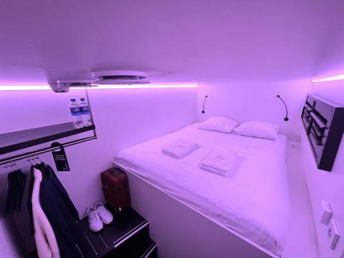 阿姆斯特丹THIS HO(S)TEL的紫色客房内的小房间,配有一张床