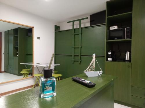 马里纳·迪·波迪斯科Monolocale a due minuti dal mare IUN R4225的绿色房间,在柜台上设有遥控器
