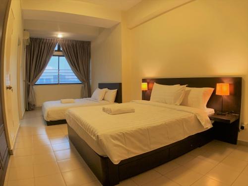 吉隆坡Bukit Bintang Fahrenheit88 Apartment by Sarah's Lodge的酒店客房设有两张床和窗户。