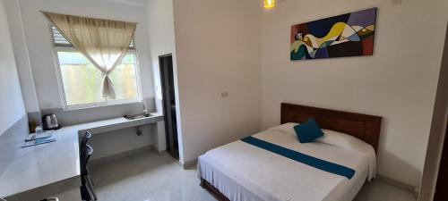 尼甘布Ceylon Lodge - Airport Transit Hotel & Hostel的一间小卧室,配有床和窗户
