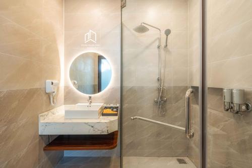 Plei Brel (2)PLEIKU HIGHLANDS BOUTIQUE HOTEL的带淋浴、水槽和镜子的浴室