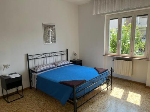 贝加莫Camere Giulia的一间卧室设有蓝色的床和2个窗户。