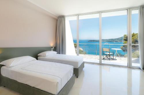 韦内雷港Cristallo Park Hotel的酒店客房设有两张床,享有海景。