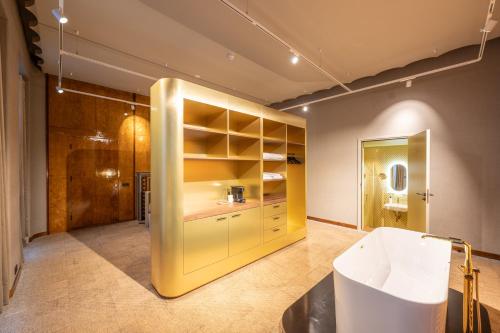 兹沃勒Hotel Staatsman的大型黄色客房设有盥洗盆和浴室