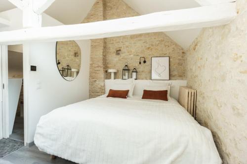 沙托鲁My Home Prestige / SPA Privatif的一间砖墙内白色床的卧室