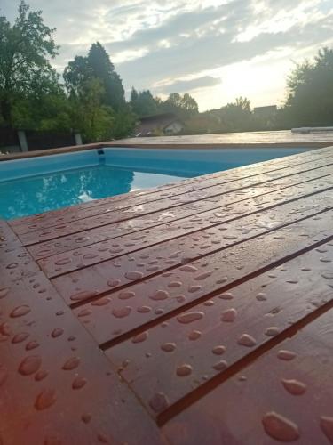 瑟切莱MONADIN Villa Relax & Spa的木制甲板上带水滴的游泳池