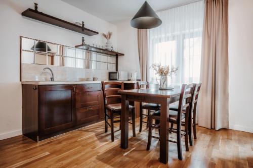 扎科帕内Apartament pod Nosalem的厨房配有木桌和木椅
