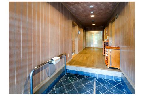 Yabu但馬長寿の郷　宿泊棟「夢」ロッジ的浴室设有瓷砖墙和有毛病的走廊