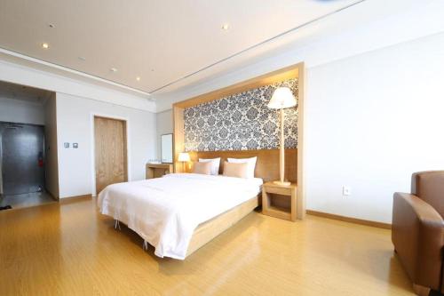 NajuLake 45 Hotel的卧室配有一张白色大床和电视。