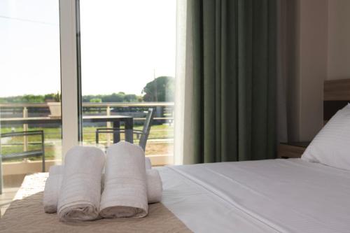 库鲁塔Apanemo Kourouta Luxury Villas的酒店客房的窗户床上配有毛巾