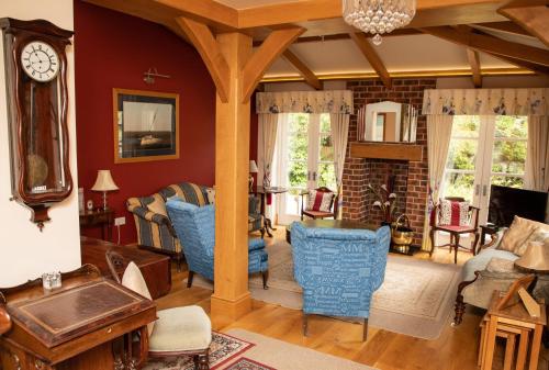 威勒尔Mere Brook House的客厅设有红色的墙壁和蓝色的椅子