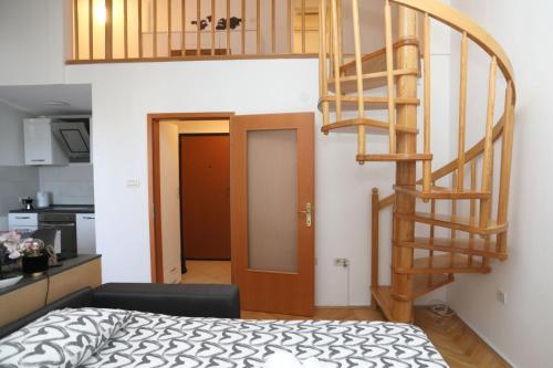 普莱曼图拉Apartman Cinkopan Premantura 1的一间设有螺旋楼梯的房间和一间卧室