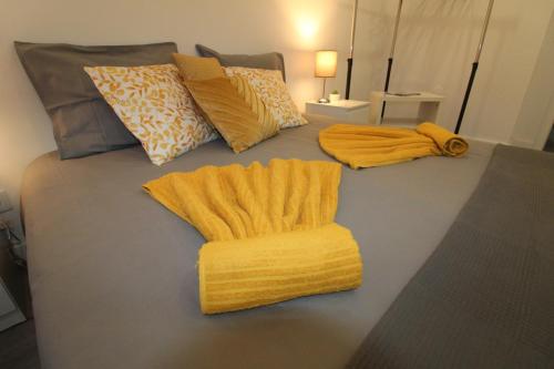 塞图巴尔Varanda do Bonfim的一张带黄色毯子和枕头的床