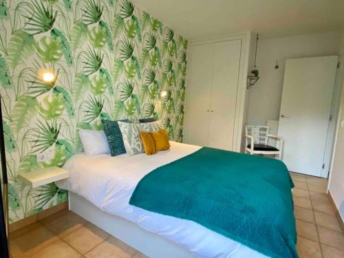 卡尼略APARTAMENTO CASA TEVA Wifi-Parquing free-Terraza的一间卧室配有一张带绿色和白色壁纸的床