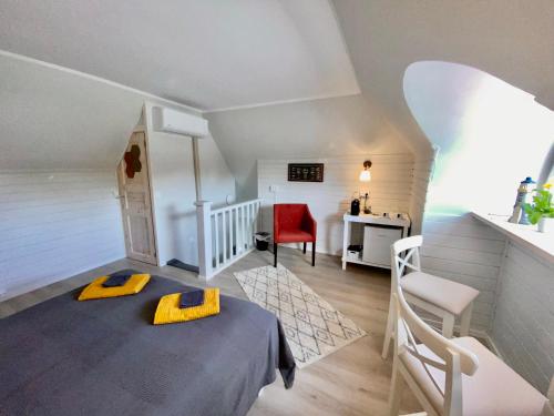 凯尔德拉Kapteni tuba - Captains room - Central Square in Kärdla的小房间设有一张床和一把红色椅子