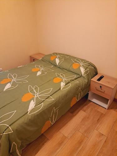 利马Zegarra' s Home的一张带绿毯的床,上面有鲜花
