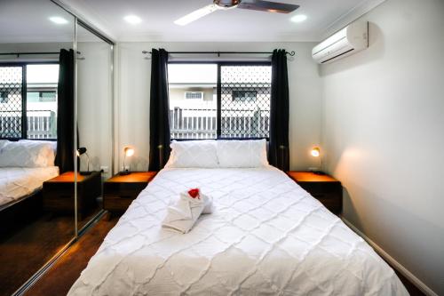 麦凯WhitsunStays - The Serenity的卧室配有白色的床和窗户。