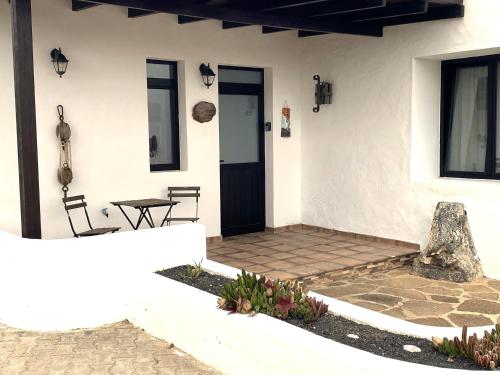 YeCasa Del Amigo Carmelo的白色的房子,配有桌子和门
