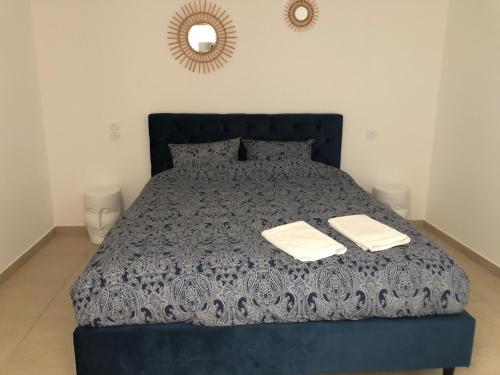 阿尔勒Casa del Sol - Piscine chauffée的一间卧室配有蓝色的床和2条毛巾