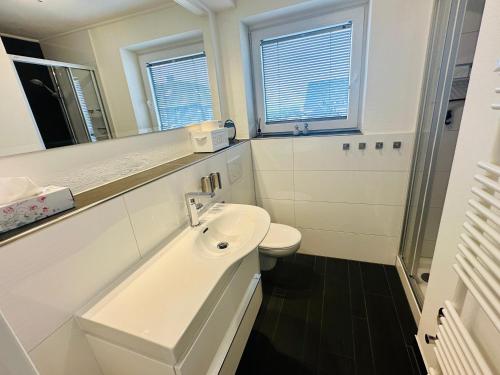 韦斯特兰Eidum 209 -strandnah-的白色的浴室设有水槽和卫生间。