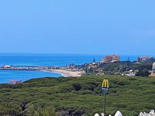 锡蒂奥卡拉翁达PRECIOSO APTO 1 LINEA PLAYA VISTAS AL MAR的海滩美景与mcdonalds标志