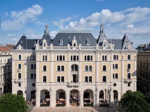 布达佩斯W Budapest的一座白色的大建筑,有灰色的屋顶