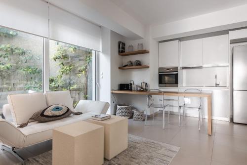 武利亚格迈尼Bliss Living的客厅配有白色的沙发和桌子