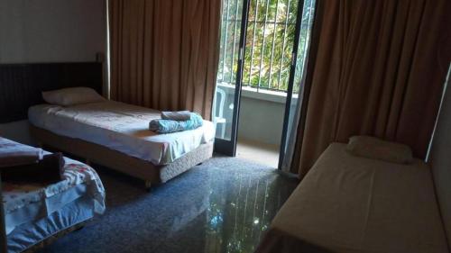 巴西利亚Beiruth Hotel的客房设有两张床和窗户。