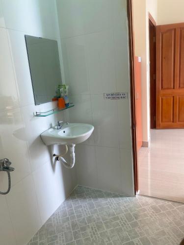 头顿Nhà Nghỉ KHÁNH NGỌC的白色的浴室设有水槽和镜子