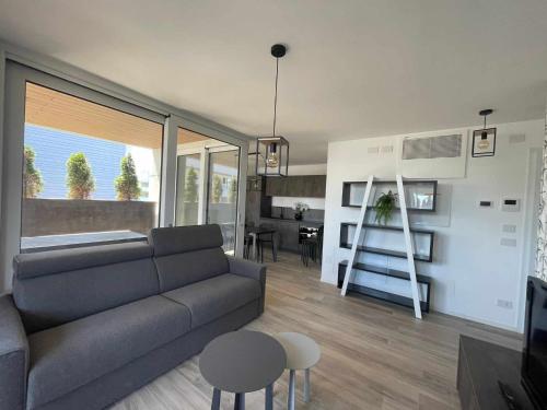 利尼亚诺萨比亚多罗MARE Appartamento 8的客厅配有沙发和桌子