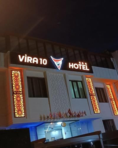 GönenVİRA10 HOTEL的前面有一个 ⁇ 虹灯标志的酒店