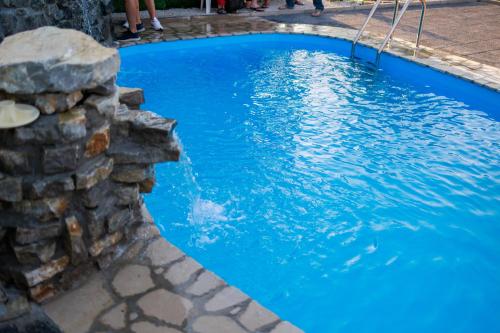 比哈奇Resort La Familia的蓝色的海水和石墙游泳池