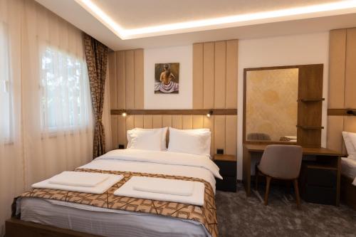 新帕扎尔Hotel M Star Novi Pazar的配有一张床和一张书桌的酒店客房