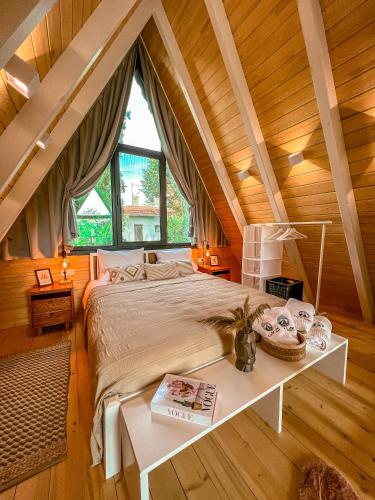 萨潘贾Cute Life Bungalow的卧室设有一张木制天花板上的大床
