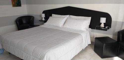 里奥马哲雷Aa Ciasèa duu Pintùu的一间卧室配有一张大床和黑色床头板