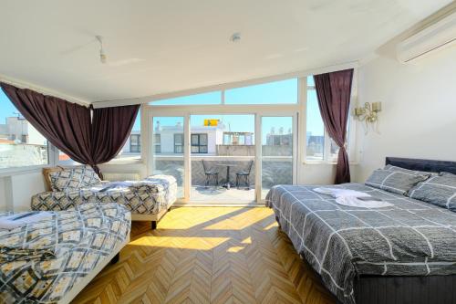 伊斯坦布尔Pearl Hotel İstanbul的酒店客房设有两张床和一个阳台。
