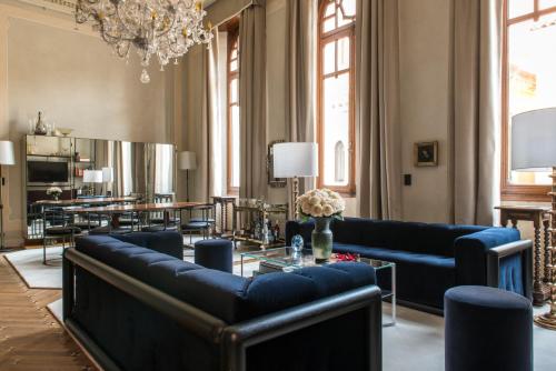 威尼斯Nolinski Venezia - Evok Collection的客厅配有蓝色的沙发和桌子